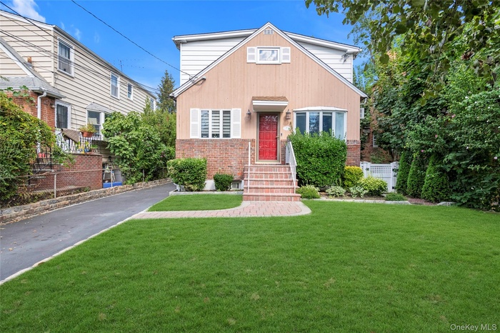View of front of home featuring brick siding