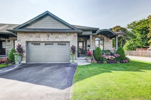Welcome to this beautifully upgraded end unit bungalow townhouse featuring a striking barrel roofline, a covered front oversized porch and a warm foyer that welcomes you home.
