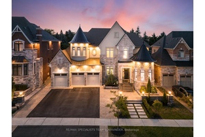 Architecturally captivating estate in sought after Sharon, set on a premium 69 x142 ft lot.