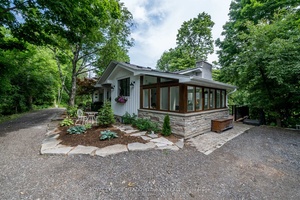 Discover this thoughtfully updated 4 bedroom residence tucked away on a quiet gravel lane in the picturesque village of Glen Williams.