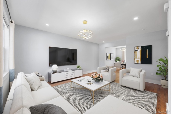 Living area featuring wood finished floors, plenty of natural light, and recessed lighting