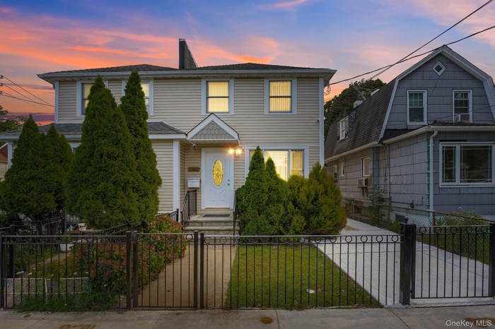 View of front of house with a gate, a fenced front yard, and a chimney