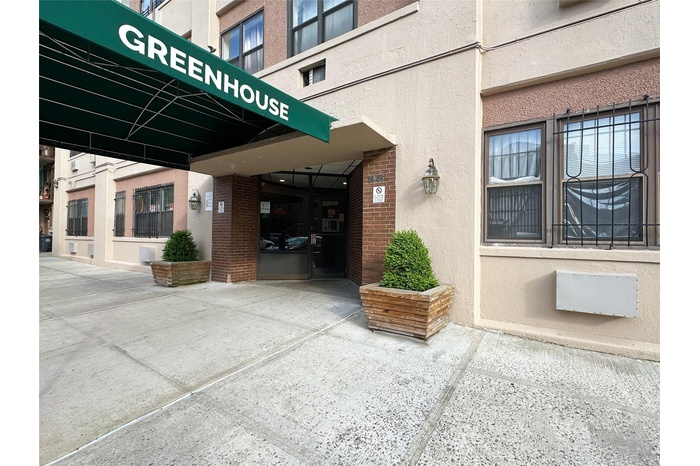 Entrance to property featuring stucco siding and brick siding