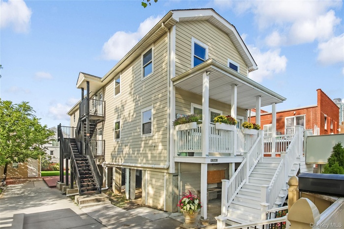 Rear view of house featuring stairs