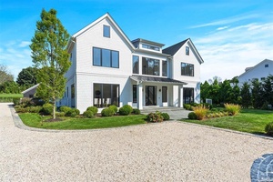 This stunning modern home offers luxurious living on 1.