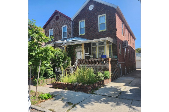 View of front of house featuring brick siding and covered porch