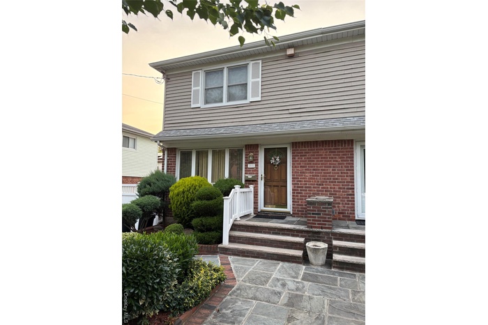 View of front of home featuring brick siding