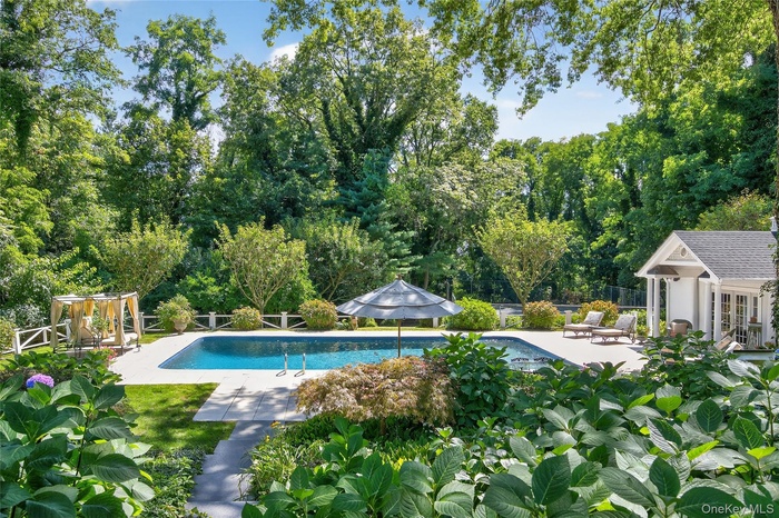 Outdoor pool with a patio, an outbuilding, a storage structure, and french doors