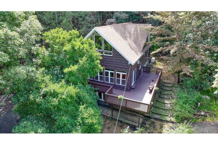Aerial view of right side of property with wrap around deck