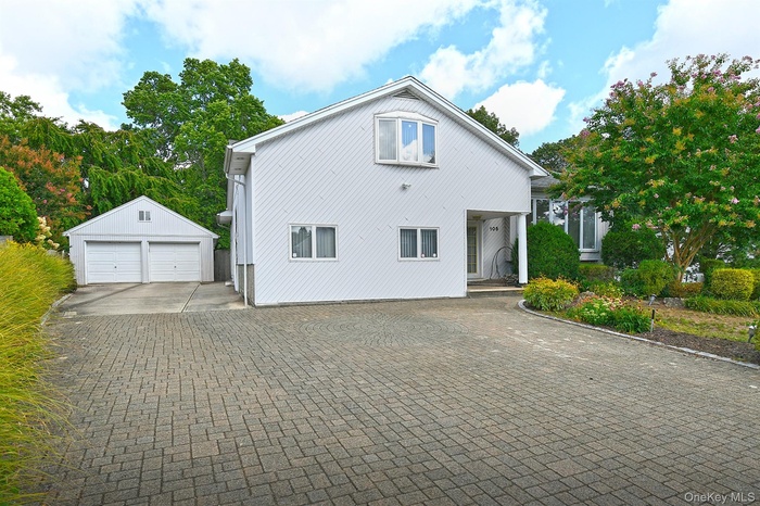 View of property exterior featuring a garage and an outbuilding