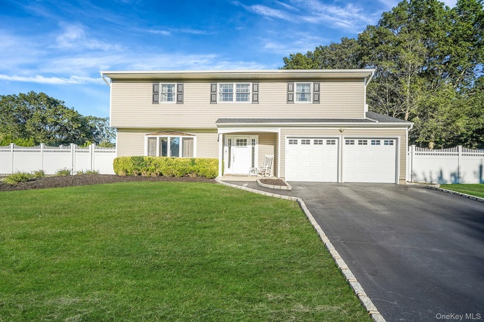 View of front of house with driveway and an attached garage