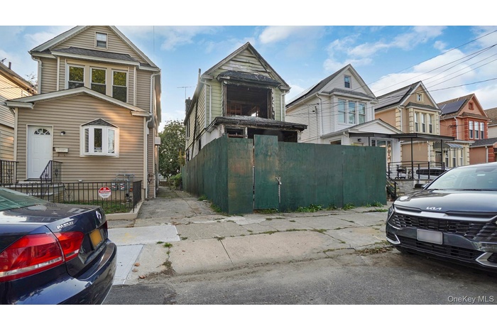 View of property exterior with a fenced front yard