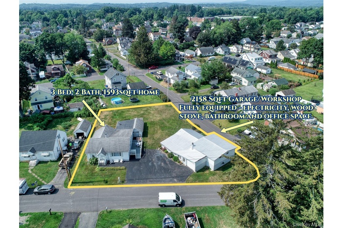 Aerial perspective of suburban area featuring property parcel outlined