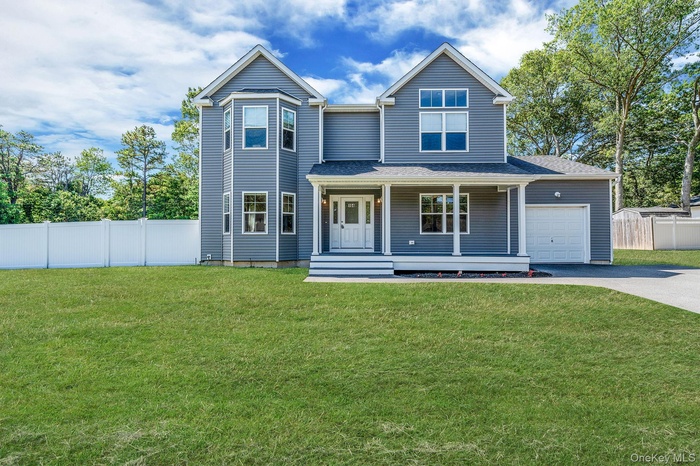 View of front of home featuring covered porch, driveway, and roof with shingles