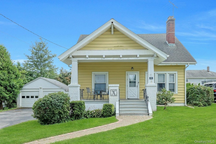 View of front of house with a porch, an outbuilding, a chimney, and a front lawnWelcome to 6 Clinton St.