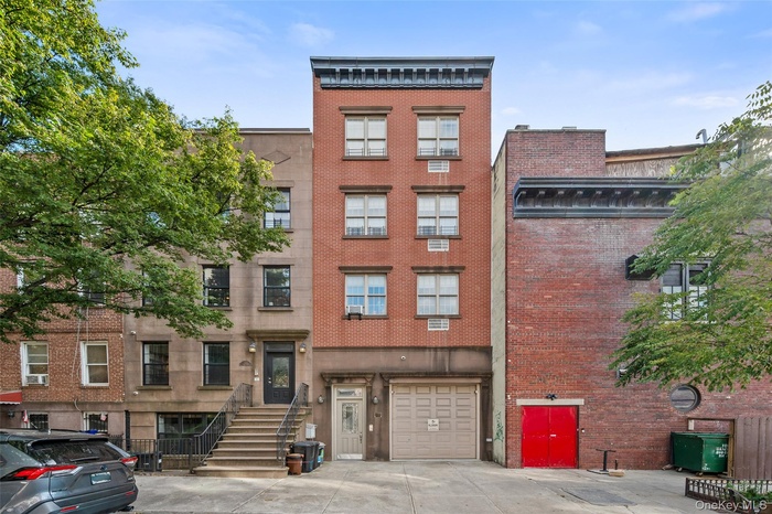 View of apartment building / complex with concrete driveway