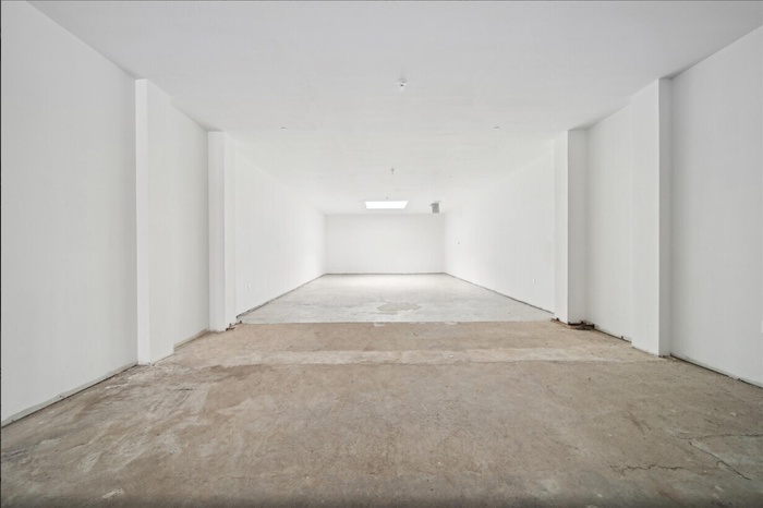 Spare room featuring unfinished concrete floors