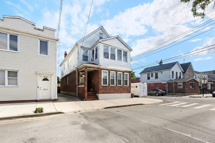Traditional-style house with a residential view and brick siding