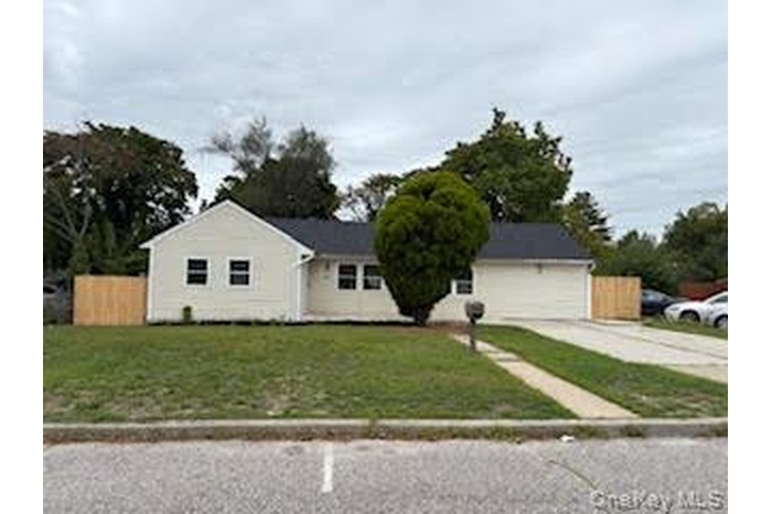 Ranch-style house with concrete driveway