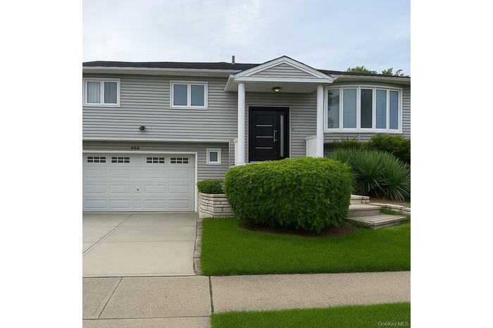 Raised ranch with driveway and a garage
