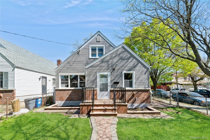 View of front of house featuring brick siding