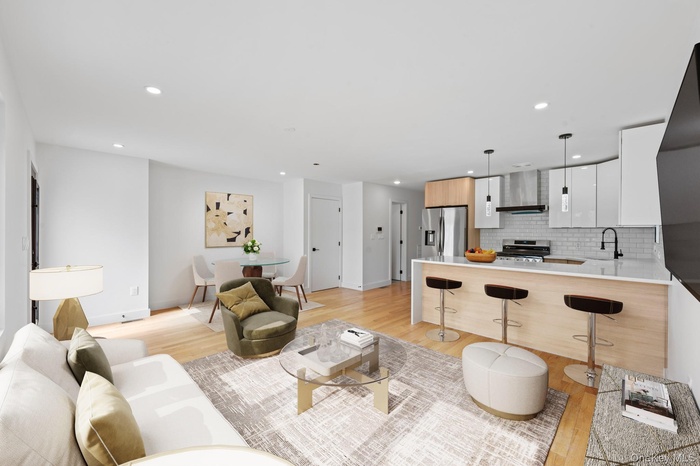 Living room featuring light wood-style flooring and recessed lighting