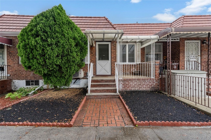 Doorway to property with brick siding