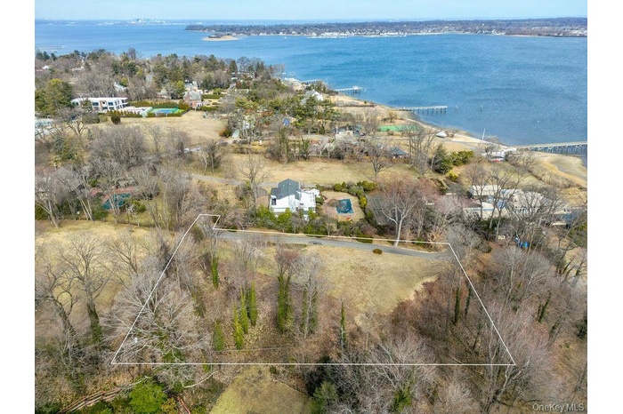 Birds eye view of property with a water view