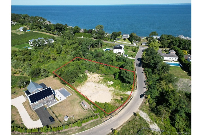 Aerial overview of property's location with property boundaries highlighted and a large body of water