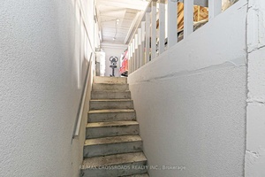Entrance To The Lower Level From The Garage With An Additional Set Of Laundry amp ; Kitchen Appliances.