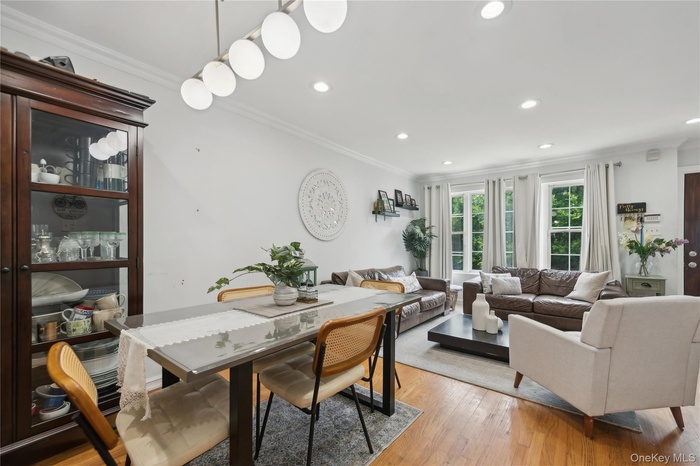 Dining room featuring crown molding, recessed lighting, and light wood-type flooring