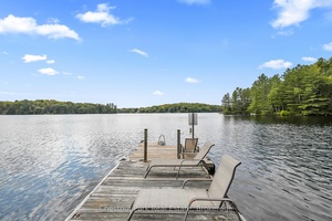YEAR ROUND COTTAGE HOME on POPULAR BAY LAKE is tucked away from the Road with 110' of SOUTHWESTERN exposure to enjoy the summer sun on your dock all day long.