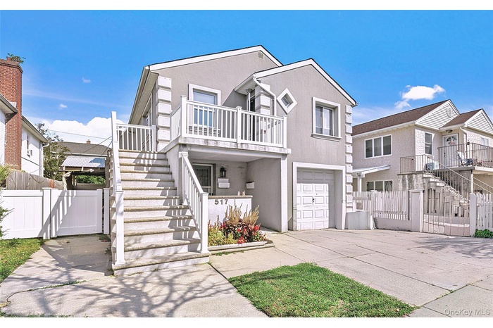 Traditional home with stairway, stucco siding, a gate, and concrete driveway