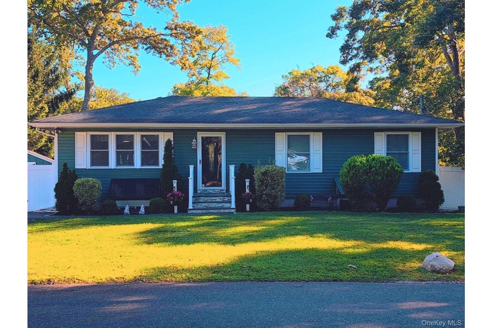 View of front facade with a front lawn and entry steps