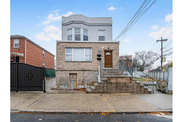 Traditional home with a gate and brick siding