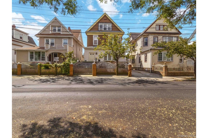 Victorian home featuring a fenced front yard and a gate