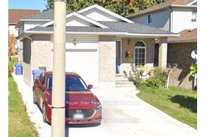 Welcome to 212 Country Club Dr, A charming 3 bedroom detached house features an open concept living and kitchen area with quartz counter top, perfect for modern living.