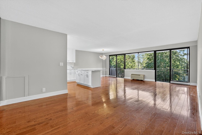 Spare room with light wood-style floors and a chandelier