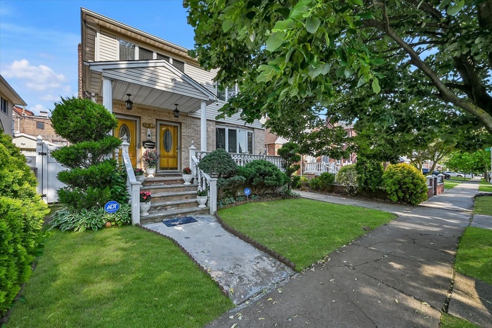View of front facade with a front yard and brick siding