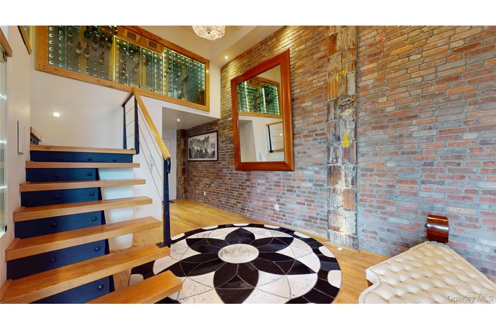 Stairway with a high ceiling and wood finished floors