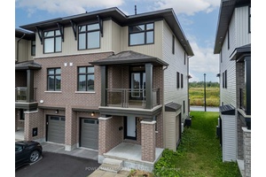 Welcome to 875 Couloir Rd, an executive 2 bedroom den, 4 bathroom end unit townhome in the desirable Trailsedge community.