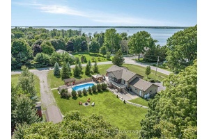 Wake up to sweeping views of Lake Ontario in this custom built bungalow that blends everyday comfort with true luxury.