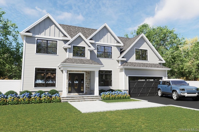 View of front of home with board and batten siding, a shingled roof, asphalt driveway, and an attached garage