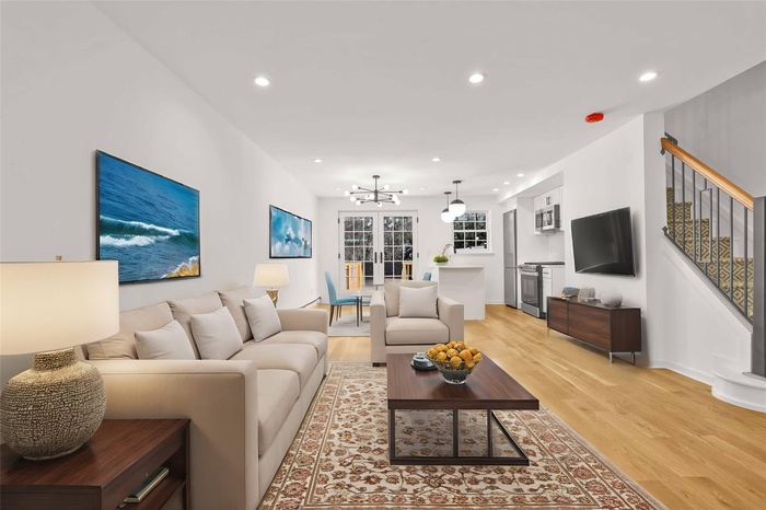 Living room featuring light wood-style floors, a chandelier, stairway, recessed lighting, and baseboards