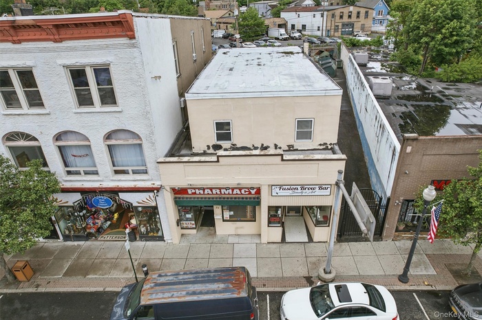 View of property featuring uncovered parking