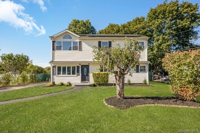 Colonial inspired home with a front lawn