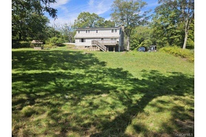 Nestled on 1. 3 acres of private property not far from the village of Monroe, this home features a oversized living room with rustic stone fireplace with pellet insert !