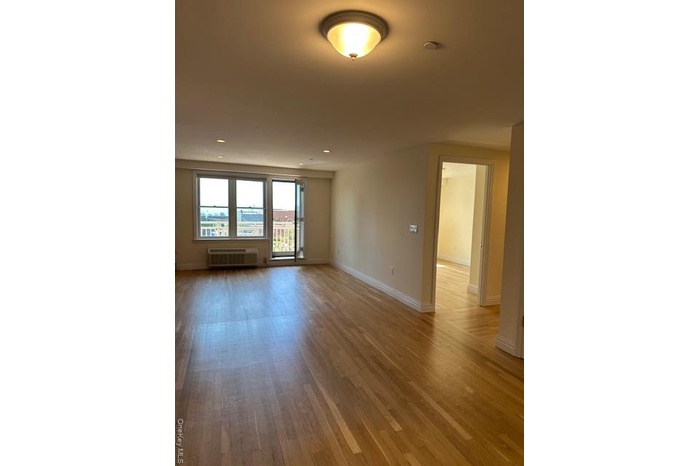 Empty room featuring light wood-type flooring and recessed lighting