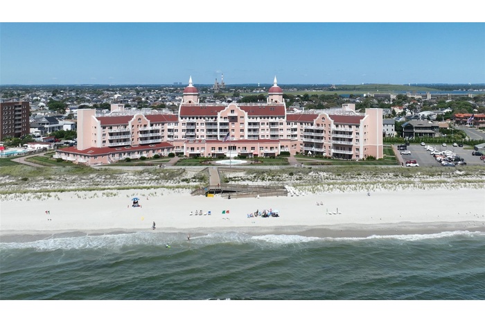 Drone / aerial view featuring a beach view and a water view