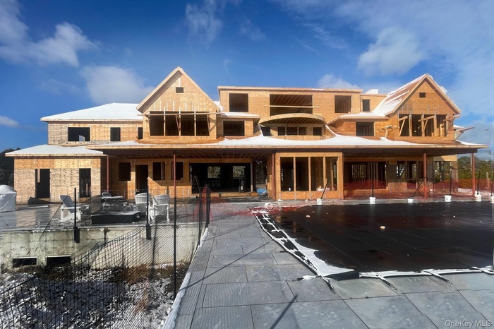 Rear view of house with stone siding